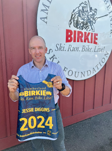 Ben Popp pictured with a custom sparkle race bib, created by Borah Teamwear, to announce Diggins' participation in the 2024 Slumberland American Birkebeiner.